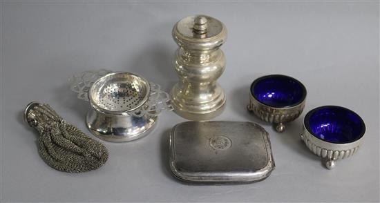 A late Victorian silver pepper mill, London, 1898, a silver travelling timepiece, a purse, two salts and a tea strainer.